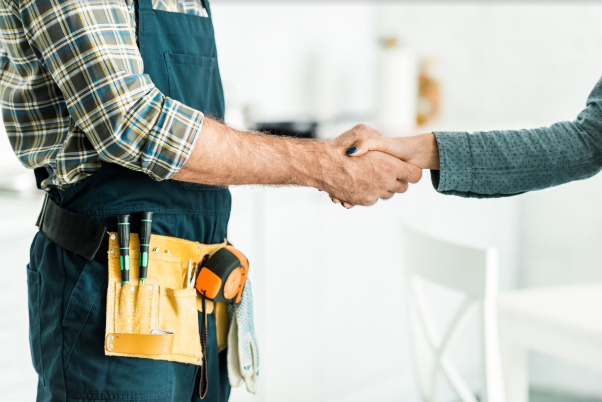 Plumber shaking homeowner's hand